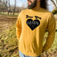 a man with a beard wearing a yellow sweatshirt