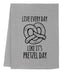 a towel with a pretzel on it saying live every day like it '
