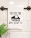 a towel hanging on a towel rack with a potted plant